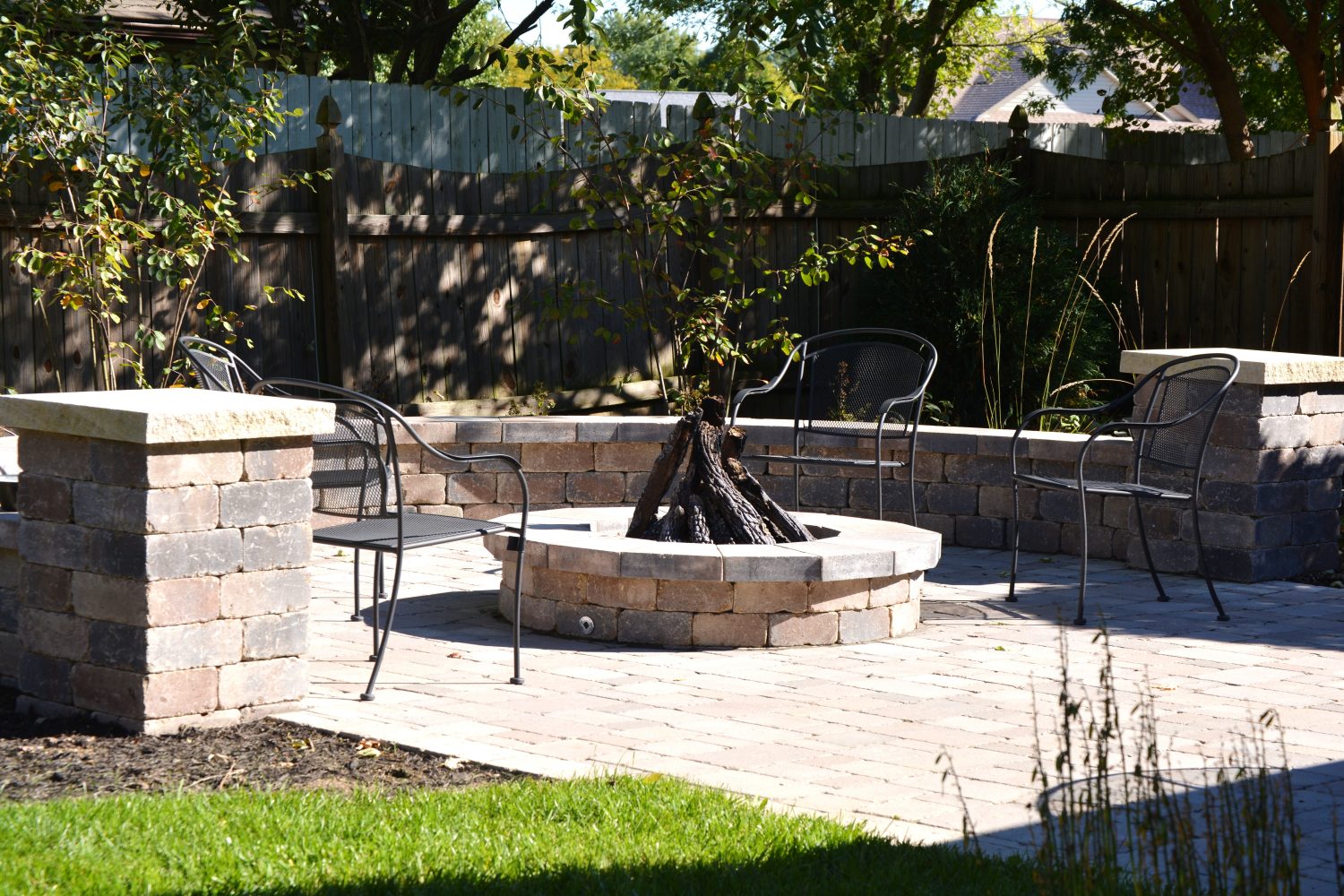 Fire Features 3 Built-in backyard fire pit on a paver surround by Plant Studio Landscape