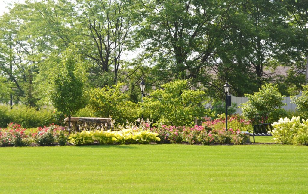 Healthy mowed lawn and maintained flower beds by Plant Studio Landscape in Muncie, Indiana